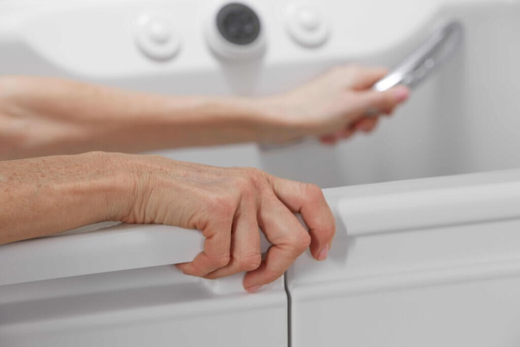 elderly woman getting out of bathtub