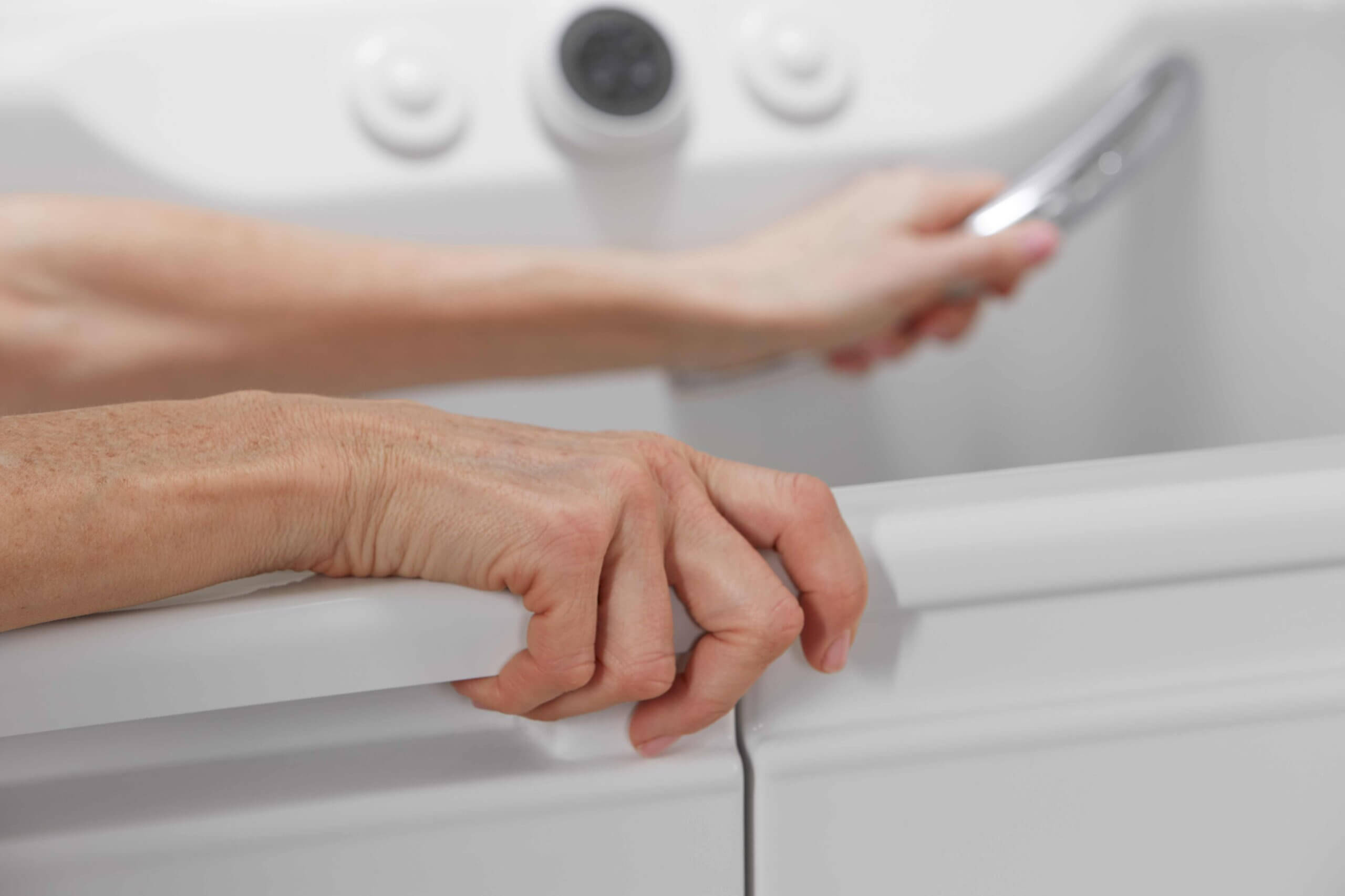 elderly woman getting out of bathtub