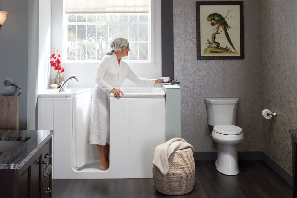 elderly woman standing in a walk-in bath